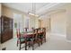 Bright dining room featuring a decorative light fixture, neutral walls, and a staircase at 5309 Mining Camp Trl, Parker, CO 80134