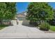 Charming two-story home with a three-car garage and a well-manicured front yard with mature trees at 5309 Mining Camp Trl, Parker, CO 80134