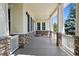 Spacious front porch with stone accents and ample room for seating, perfect for enjoying the outdoors at 5309 Mining Camp Trl, Parker, CO 80134