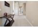 Hallway featuring neutral tones and a wood console table and artwork at 5309 Mining Camp Trl, Parker, CO 80134