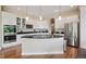 Kitchen with granite countertops, stainless appliances, breakfast bar, and hardwood floors at 5309 Mining Camp Trl, Parker, CO 80134