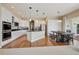 Spacious kitchen features white cabinetry, granite countertops, stainless steel appliances and hardwood floors at 5309 Mining Camp Trl, Parker, CO 80134