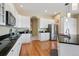 Modern kitchen featuring granite countertops, stainless steel appliances, white cabinetry and hardwood floors at 5309 Mining Camp Trl, Parker, CO 80134