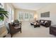 Bright living room with large windows, plantation shutters, and comfortable seating for a cozy atmosphere at 5309 Mining Camp Trl, Parker, CO 80134
