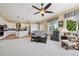 Bright living room featuring a ceiling fan, neutral decor, and large windows that provide ample natural light at 5309 Mining Camp Trl, Parker, CO 80134