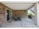 Covered patio with brick siding and a table with chairs at 5309 Mining Camp Trl, Parker, CO 80134