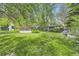 The backyard offers a view of the pool and mature trees at 2220 Lee St, Lakewood, CO 80215