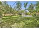 The grassy yard features a pool with a shed and a wood fence at 2220 Lee St, Lakewood, CO 80215