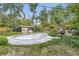 The in-ground pool is surrounded by a tile border and lush landscaping at 2220 Lee St, Lakewood, CO 80215