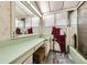 Bathroom featuring a green countertop, shower, large mirror, and vanity, offering a functional space at 2220 Lee St, Lakewood, CO 80215