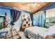 Bedroom featuring wood ceiling, blue walls, blue curtains, and vintage-style decor at 2220 Lee St, Lakewood, CO 80215