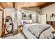 Bedroom featuring a large mirror, decor, and wooden ceiling, offering a comfortable and stylish space at 2220 Lee St, Lakewood, CO 80215