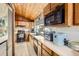 View of the kitchen with wooden ceiling, tile floor, black appliances and plenty of natural light at 2220 Lee St, Lakewood, CO 80215