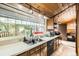 Bright kitchen featuring a large window, wood ceiling, stainless steel appliances, and natural light at 2220 Lee St, Lakewood, CO 80215