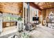 Open-concept living space featuring a wood-burning stove, kitchen, and access to outdoor views at 2220 Lee St, Lakewood, CO 80215