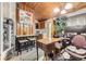 Combination office and dining nook with wooden ceiling, carpeted floor, and adjacent kitchen view at 2220 Lee St, Lakewood, CO 80215