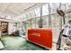 The sunroom's skylight floods the area with natural light, highlighting a vintage Coca-Cola beverage cooler at 2220 Lee St, Lakewood, CO 80215
