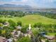 An aerial view showcasing a home surrounded by trees, and scenic landscape at 14023 W Alaska Dr, Lakewood, CO 80228