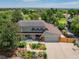 An overhead view of the home highlighting its solar panels, lush greenery, and well-maintained landscaping at 14023 W Alaska Dr, Lakewood, CO 80228
