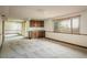 Spacious carpeted basement area with built-in cabinets and a window at 14023 W Alaska Dr, Lakewood, CO 80228