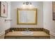 Classic bathroom with stylish mirror, decorative tile, and good lighting for a fresh look at 14023 W Alaska Dr, Lakewood, CO 80228