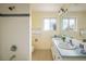 Bathroom with a double sink vanity, tiled shower, and modern fixtures at 14023 W Alaska Dr, Lakewood, CO 80228