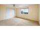 Bright bedroom with neutral carpet, a window, and a spacious closet for comfortable living at 14023 W Alaska Dr, Lakewood, CO 80228