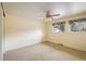 Spacious bedroom featuring carpet floors, ceiling fan, and natural light from two windows at 14023 W Alaska Dr, Lakewood, CO 80228