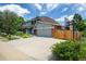 Two-story home with attached garage, large driveway and basketball hoop at 14023 W Alaska Dr, Lakewood, CO 80228