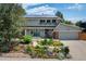 Charming two-story home with a well-manicured lawn and solar panels on the roof at 14023 W Alaska Dr, Lakewood, CO 80228