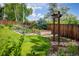 Well-kept garden with raised beds and a decorative arbor at 14023 W Alaska Dr, Lakewood, CO 80228