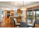 Bright kitchen with a central island, stainless steel appliances, and sliding glass doors leading to a deck at 14023 W Alaska Dr, Lakewood, CO 80228