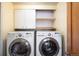Laundry room featuring a washer, dryer, and storage cabinets at 14023 W Alaska Dr, Lakewood, CO 80228