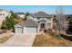Stunning aerial view of a home featuring a spacious driveway and manicured lawn at 16590 Hitching Post Cir, Parker, CO 80134