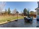 Spacious backyard with patio, basketball hoop, dining set, and grass at 16590 Hitching Post Cir, Parker, CO 80134