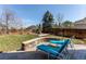 Spacious backyard featuring patio, lush lawn, and a stone fire pit area, perfect for outdoor gatherings at 16590 Hitching Post Cir, Parker, CO 80134