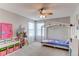 Charming bedroom with a princess theme, decorative bed frame, ceiling fan and lots of natural light at 16590 Hitching Post Cir, Parker, CO 80134