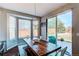 Dining area with large wooden table, bench seating, and a sliding door leading to the backyard at 16590 Hitching Post Cir, Parker, CO 80134