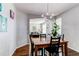 Dining room with hardwood floors, chandelier, and views into the living room at 16590 Hitching Post Cir, Parker, CO 80134