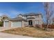 Charming two-story home with a three-car garage and well-manicured lawn at 16590 Hitching Post Cir, Parker, CO 80134
