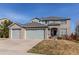 Traditional brick home with a three-car garage and well-manicured lawn in a suburban neighborhood at 16590 Hitching Post Cir, Parker, CO 80134