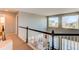 Upper hallway with carpet floors and view of the main floor at 16590 Hitching Post Cir, Parker, CO 80134