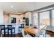 Bright kitchen features granite counters, stainless steel appliances, white cabinets and opens to a dining area with a farmhouse table at 16590 Hitching Post Cir, Parker, CO 80134