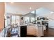 Open-concept kitchen boasts granite counters, stainless appliances, and hardwood floors, seamlessly connecting to the living area at 16590 Hitching Post Cir, Parker, CO 80134