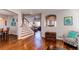 View of living room showing staircase with wood floors and decor at 16590 Hitching Post Cir, Parker, CO 80134