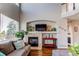 Living room view of fireplace with tall ceilings and large windows at 16590 Hitching Post Cir, Parker, CO 80134