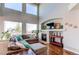 Open living room with large windows and a cozy fireplace at 16590 Hitching Post Cir, Parker, CO 80134
