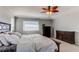 Bright main bedroom featuring carpet floors, a ceiling fan, and a large window at 16590 Hitching Post Cir, Parker, CO 80134