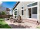 A brick patio with a dining set sits outside this home's backyard at 1374 Spotted Owl Way, Highlands Ranch, CO 80129