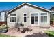 Brick patio in a sunny backyard with a patio set and easy access to the house at 1374 Spotted Owl Way, Highlands Ranch, CO 80129